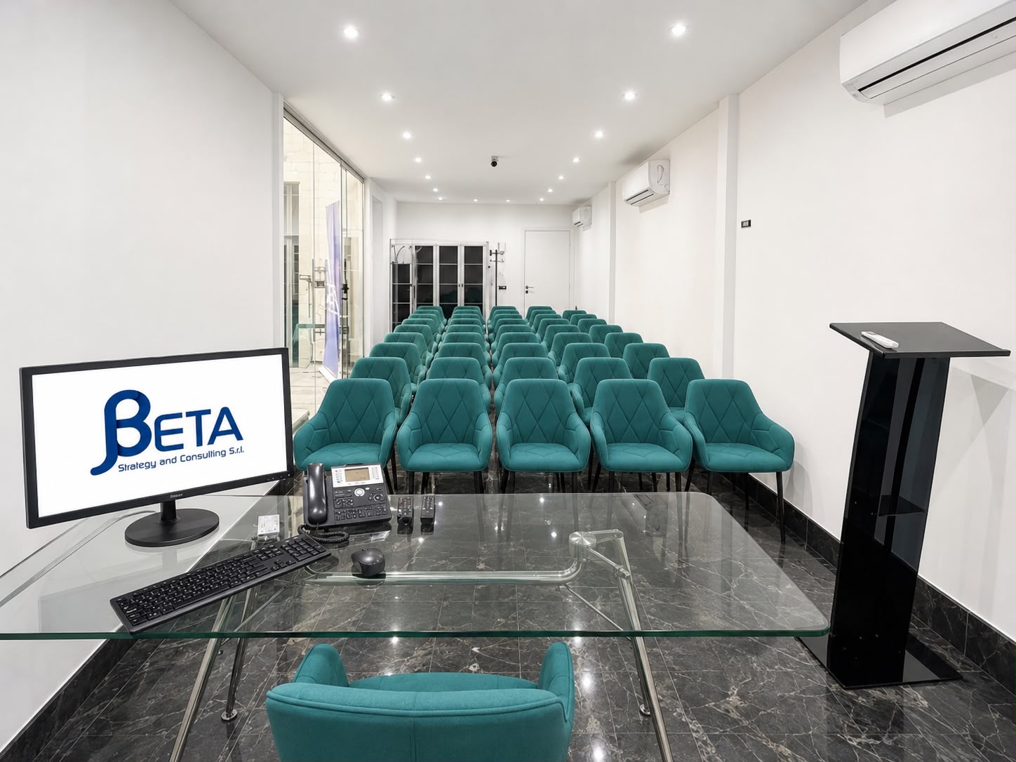 Sala conferenze con poltrone e podio